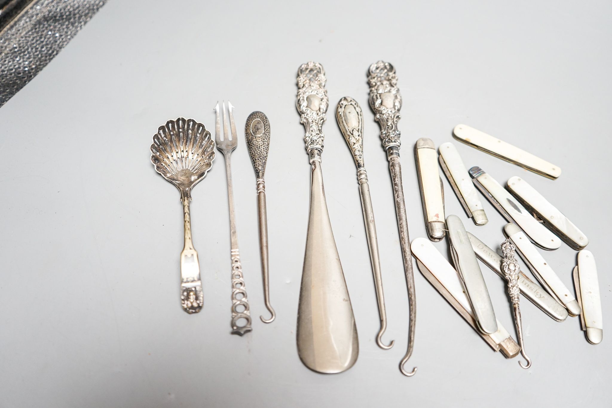 Eight various silver bladed fruit knives, three silver handled button hooks and silver handled shoe horn and button hook set